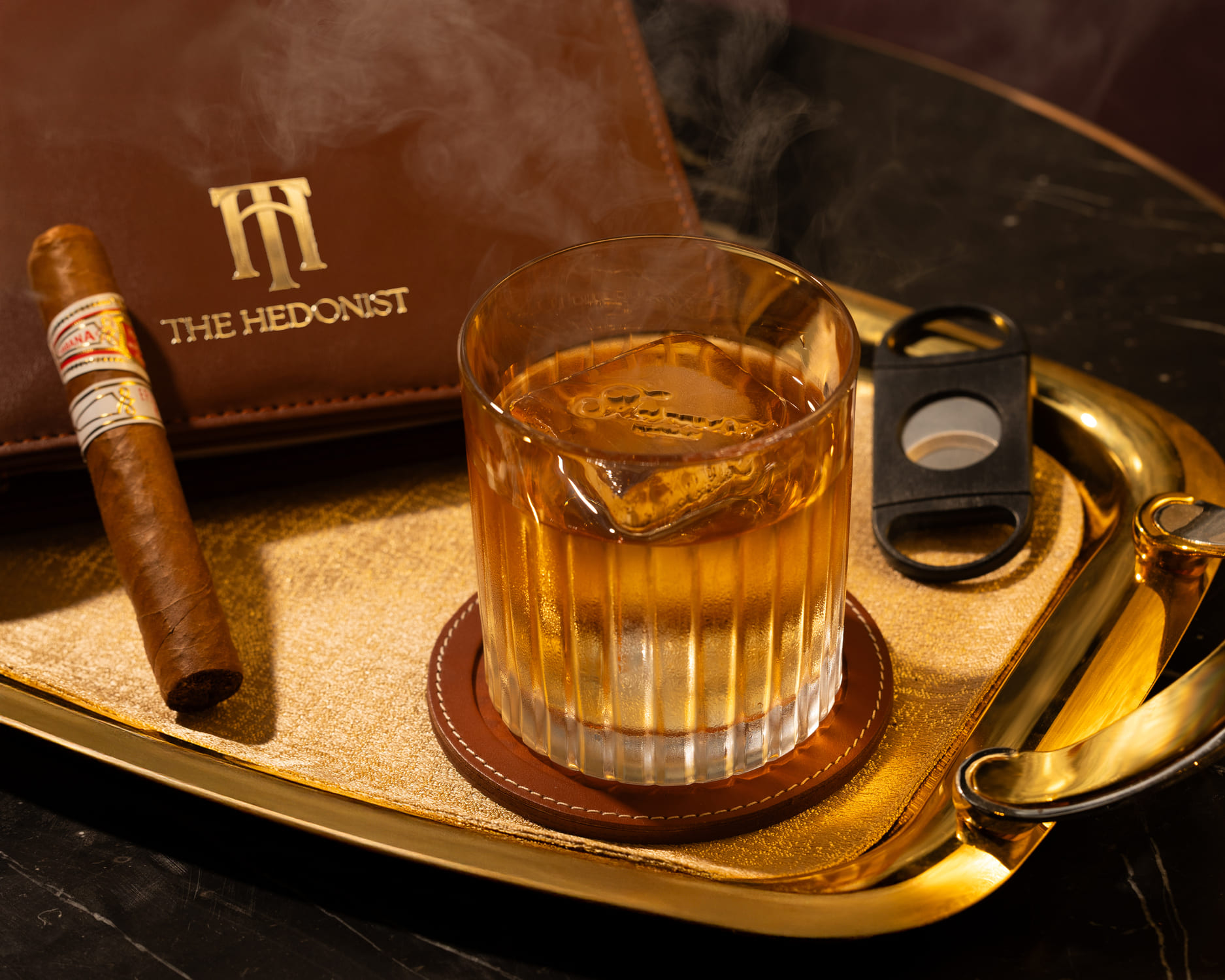 Close-up of a whisky glass, and cigar